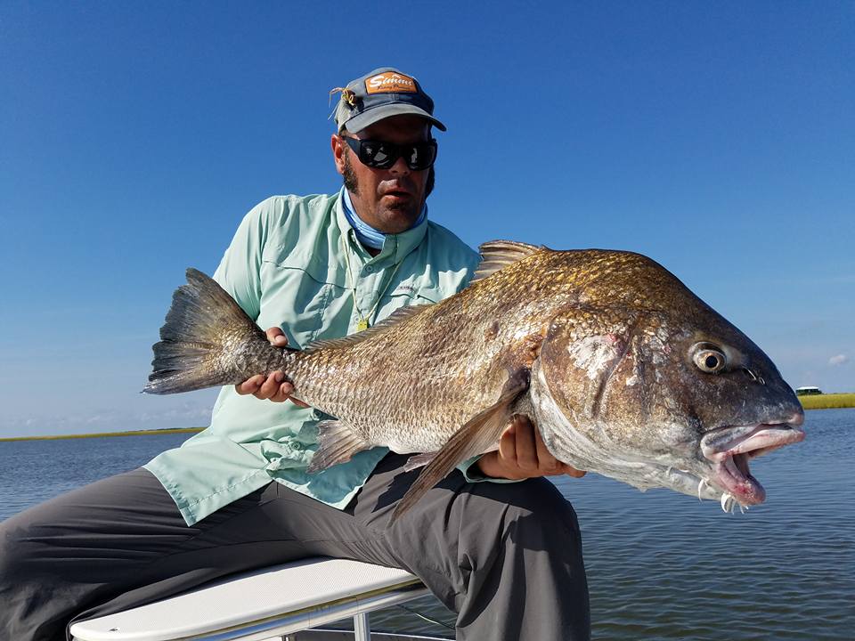 Capt. Ron Ratliff with a rod bending Black Drum in Louisiana.