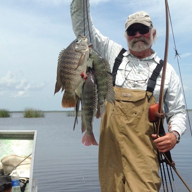 Flip getting Tilapia in the Boat.