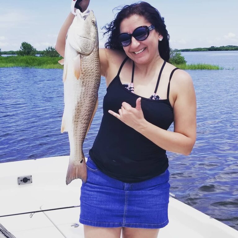 Ingrid showing off her first redfish ever coming in just over 30″