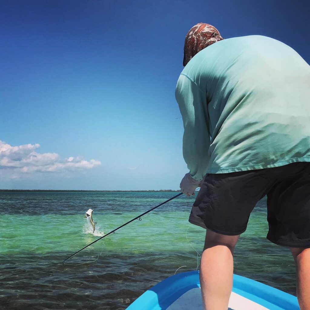 El diablo blanco jumping a baby tarpon at Isla Blanca